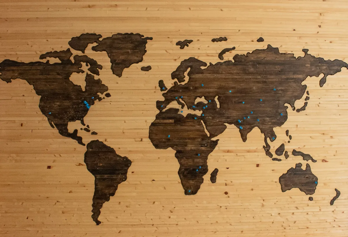 Wooden world globe with carved connection lines
