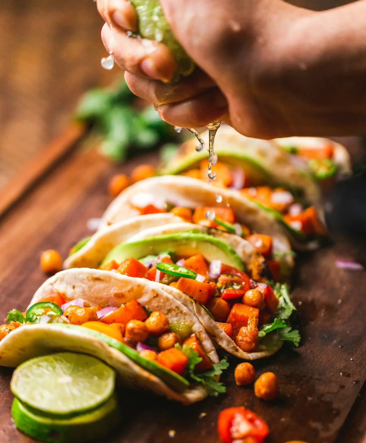 Vegan tacos on a wooden board with lime slices